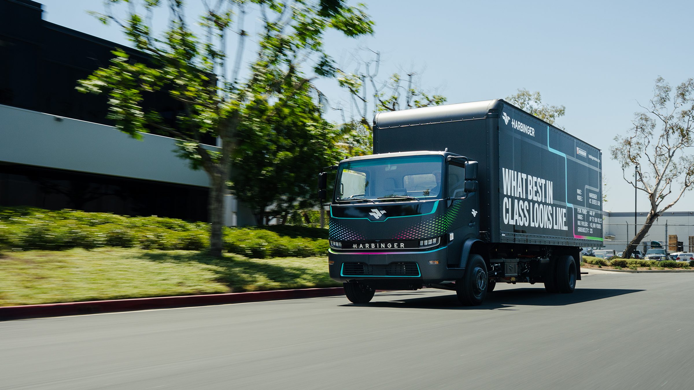 Harbinger HC Series Cab box truck driving on a tree-lined road
